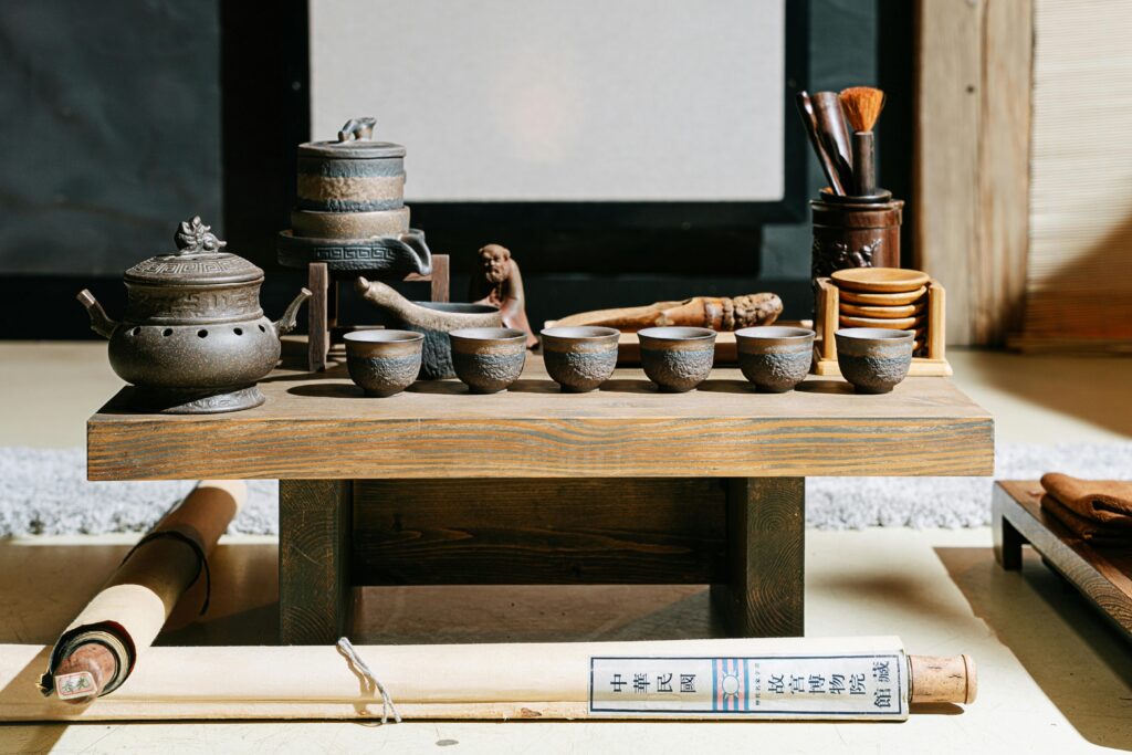 A beautifully crafted artisan tea set displayed on a rustic wooden table, embodying traditional elegance.