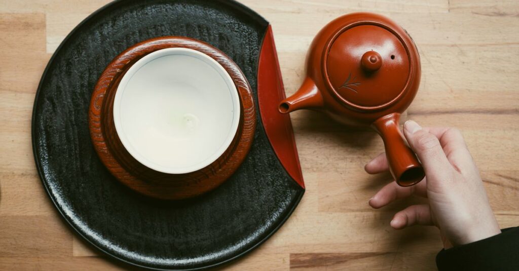 Japanese teapot and cup on wooden table, capturing a serene tea moment.