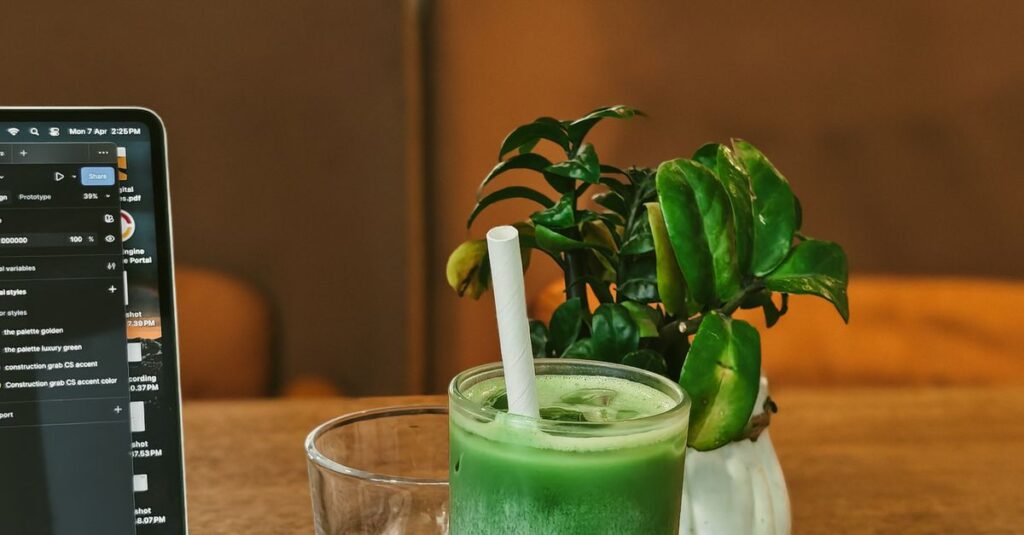 A cozy cafe setup featuring a laptop, matcha latte, and greenery, ideal for freelancers.
