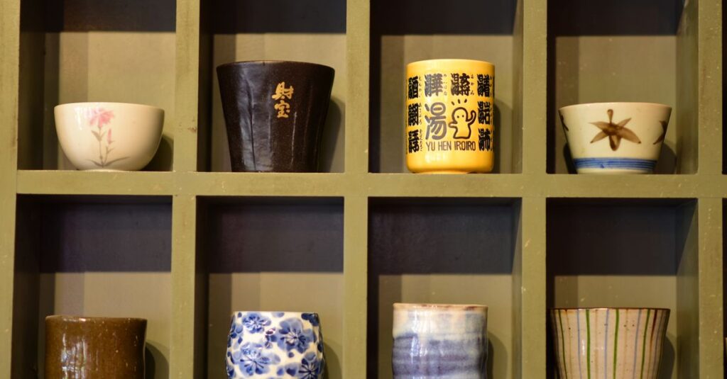 An array of decorative ceramic cups displayed in wooden cubby shelves with artistic designs.