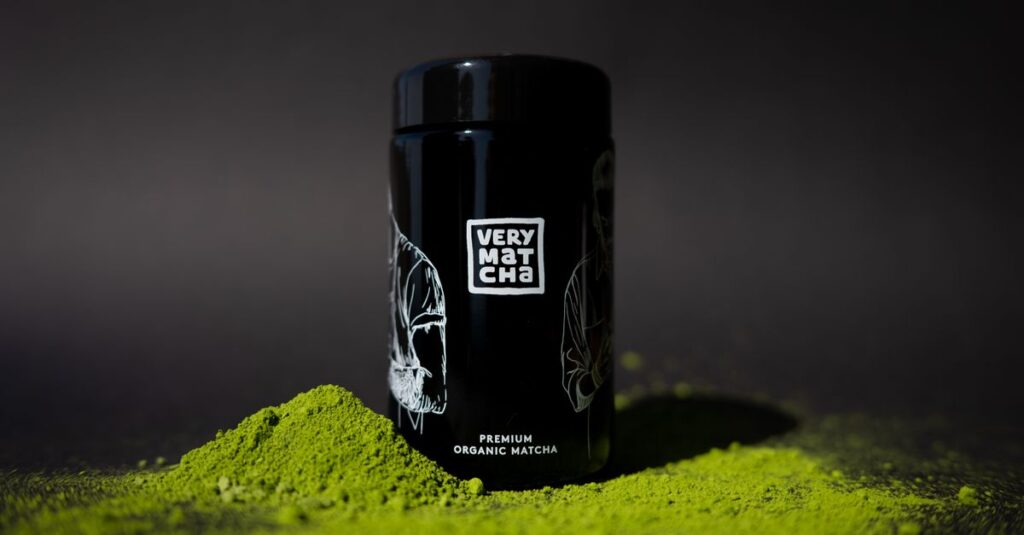 Photo of premium organic matcha with black packaging against a dark background.