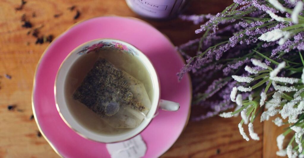Enjoy a calming herbal tea with lavender and aromatic herbs in a pink floral teacup.