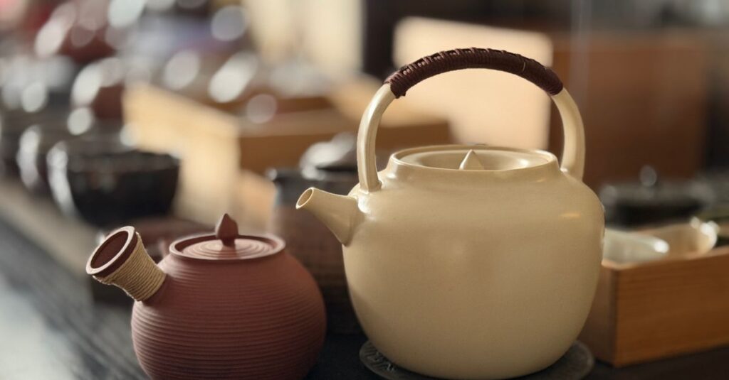 Charming ceramic teapots in a cozy tea shop setting, ideal for Asian decor or tea culture themes.