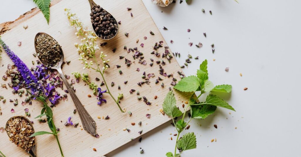 Overhead shot of herbs and spices on a wooden chopping board with spoons, showcasing culinary ingredients.