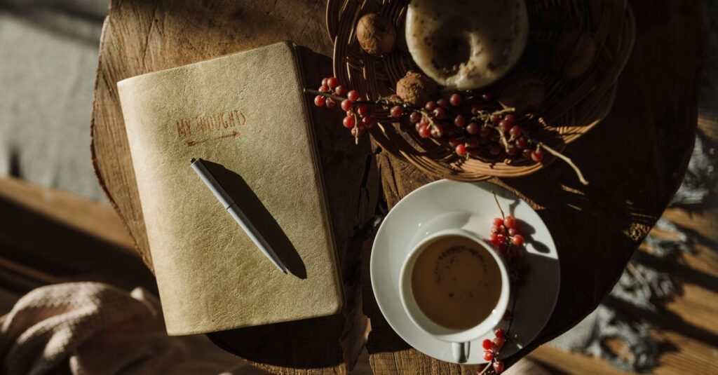 A warm, inviting scene with tea, notebook, and pastries on a rustic wooden table.