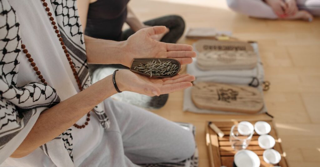 A peaceful indoor meditation session featuring herbal ceremony tools and participants engaged in alternative therapy.