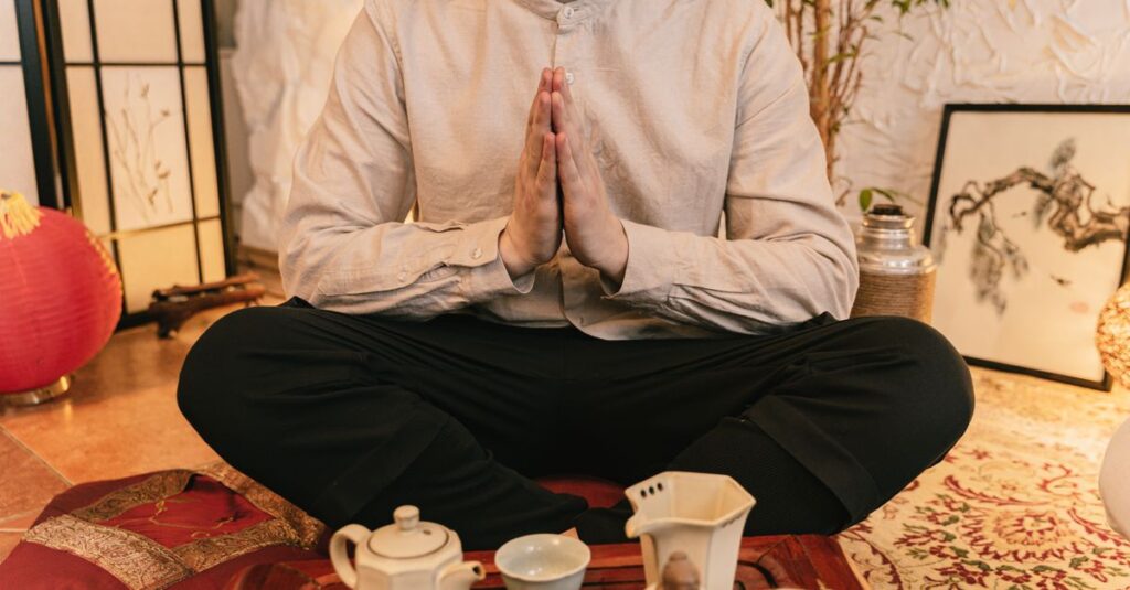 A serene tea ceremony with a man practicing mindfulness indoors.