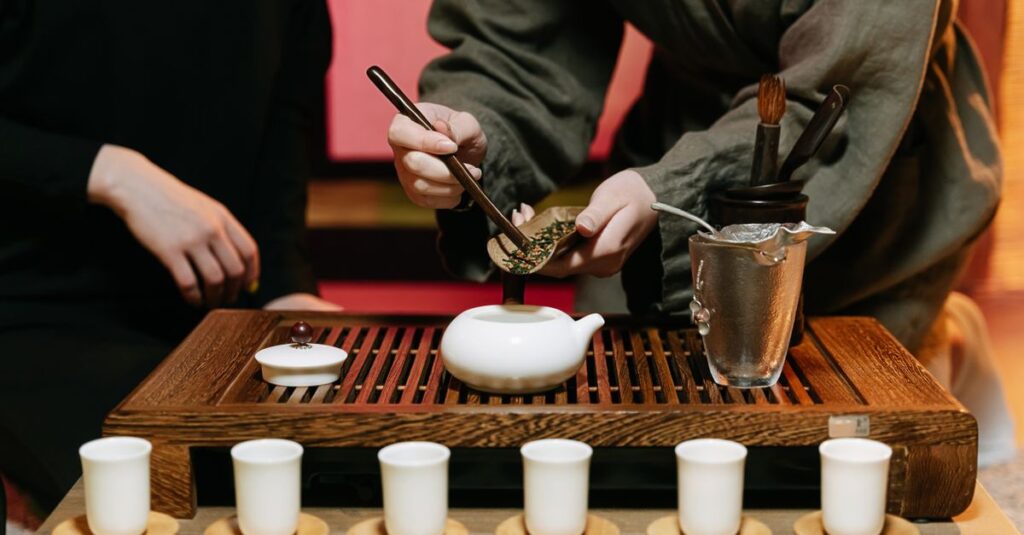 Two individuals participate in a traditional tea ceremony, highlighting the elegance and precision involved.