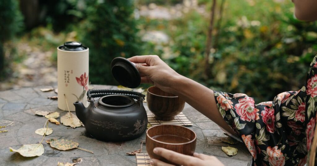 A serene Japanese tea ceremony outdoors with a woman in a floral kimono preparing tea.